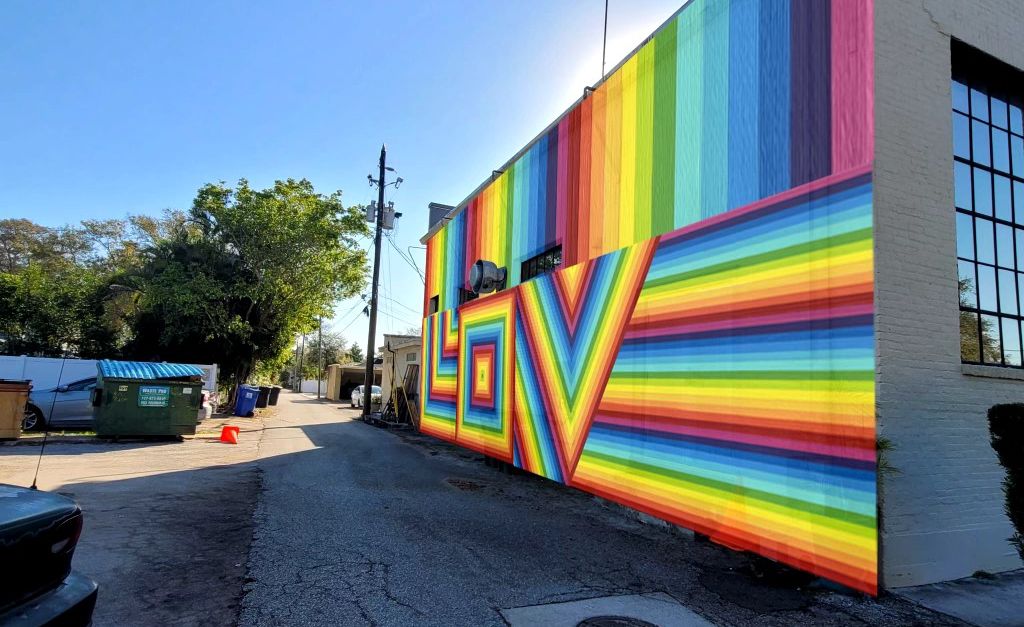 It will take more than 100 cans of paint to complete the rainbow mural, with the word 